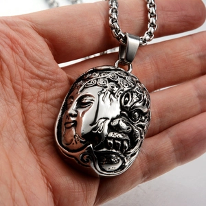 Vintage stainless steel necklace featuring double-sided Buddha and demon relief pendant