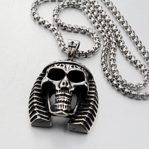Macro detail of Pharaoh skull pendant in titanium steel with intricate engraved cross bail
