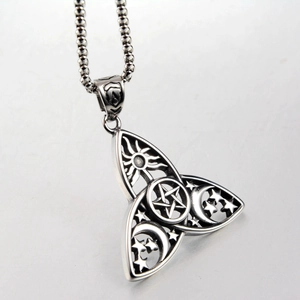 Macro shot of stainless steel Celtic knot pendant with sun moon and star engravings