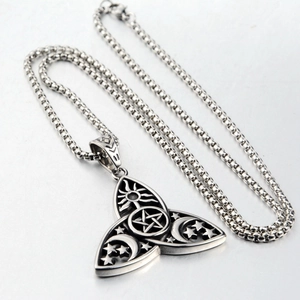 Detailed macro view of Celtic Triquetra pendant with pentagram and celestial moon engravings