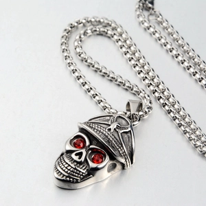 Detail of skull pendant with military cap and red crystal eyes on stainless steel chain