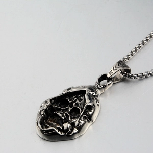 Macro view of gothic hollow skull pendant with vintage oxidation effect and box chain