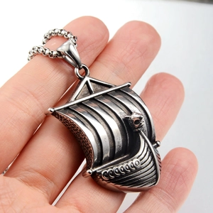 Close-up of Viking longship pendant with skull detail and antique silver finish