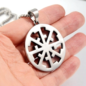 Macro view of Slavic Kolovrat sun wheel pendant made of durable polished stainless steel