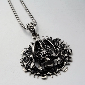 Macro view of vintage silver skeleton and snake pendant with antique finish on box chain