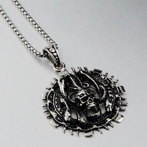 Detail of gothic punk skull and scorpion pendant with gear edge on box chain