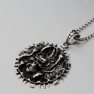 Close-up of vintage punk skull pendant necklace with gear-shaped edge in silver finish