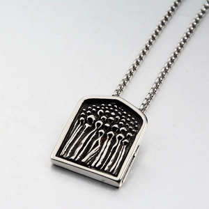 Detailed close-up of Gothic shield pendant with figure relief and steel box chain