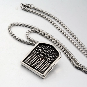 Detailed view of the punk style matchstick embossed shield pendant on a stainless steel chain