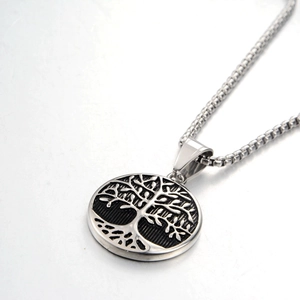 Detailed close-up of tree of life pendant on a silver box chain made of titanium steel