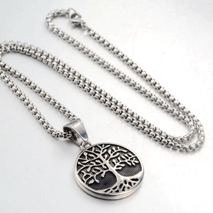 Macro detail of Tree of Life pendant featuring intricate relief and box chain