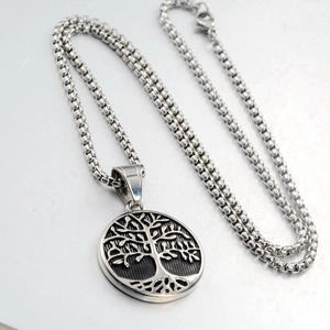 Detail of silver tree of life pendant with box chain made of polished stainless steel