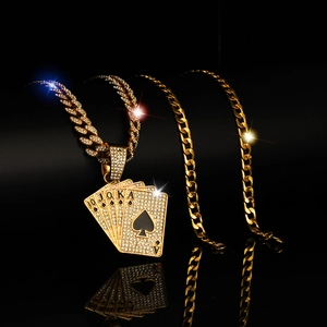 Macro shot of gold-plated hip hop Cuban chain with sparkling iced-out poker cards pendant