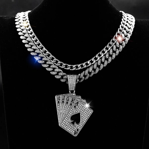 Hip hop cuban link necklace with iced-out spade poker cards pendant on a black bust display
