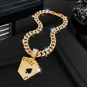 Macro shot of gold-plated hip hop poker cards pendant encrusted with sparkling crystals