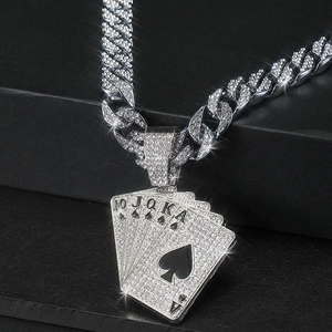 Macro shot of hip hop pendant featuring five iced-out poker cards with black spade details