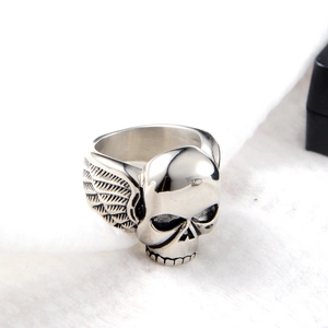 Macro side view of hip hop punk ring featuring skull and wing details on silver metal