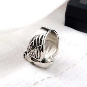 Macro shot of gothic wing ring with vintage skull design and antique silver finish