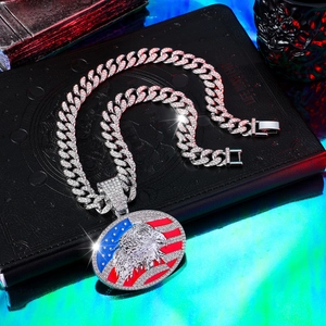 Macro shot of iced-out eagle pendant with USA flag design on thick Cuban chain link