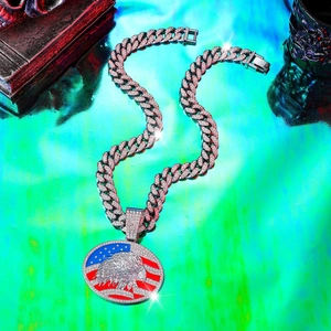 Detail of hip hop Cuban link necklace with American flag eagle pendant and white zircons