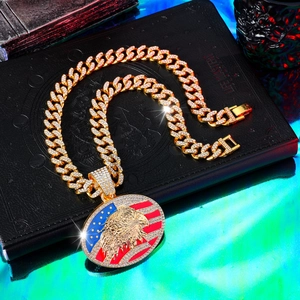 Close-up of hip hop gold plated Cuban link chain with iced out American flag eagle pendant