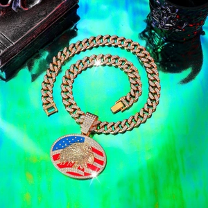 Detailed close-up of iced out eagle pendant with US flag on gold hip hop Cuban chain