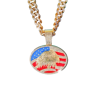 Iced out gold hip hop necklace featuring an American flag and eagle pendant with crystals