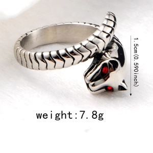 Macro view of leopard head ring with red rhinestone eyes and textured metal details
