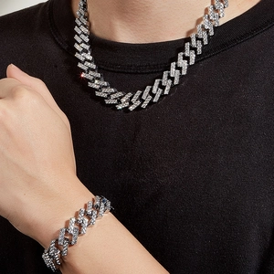 Close-up of iced out cuban link necklace and bracelet set with white crystals for men
