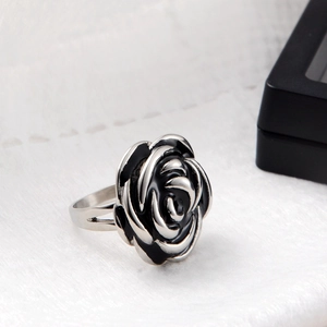 Detail view of retro silver rose ring with black enamel accents and gothic carved petals