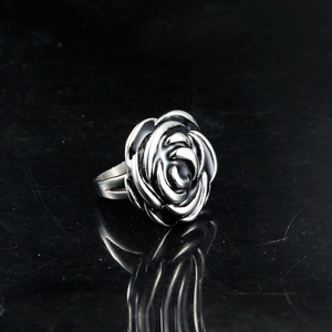 Detailed macro shot of vintage silver rose ring with black gothic floral relief
