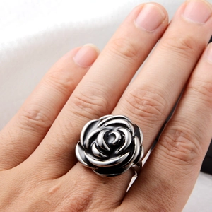 Detail of 3D layered black rose ring with silver edges worn on a finger