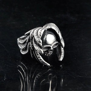 Macro shot of gothic skull ring with feather wings in vintage silver stainless steel