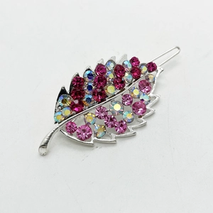 Detailed view of leaf shaped hair clip featuring sparkling pink and aurora rhinestones