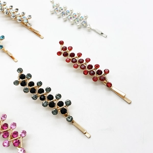Close-up of sparkling colorful rhinestone bobby pins in gold and silver plating