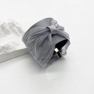 Detail showing high-quality gray satin ribbon and sheer mesh bow with golden metal hook