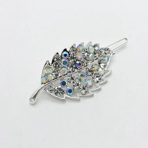 Detailed view of silver leaf-shaped hair clip with shimmering rhinestones and AB crystal finish
