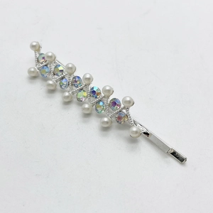 Detail of colorful AB rhinestones and white pearls on a silver-plated alloy hair clip