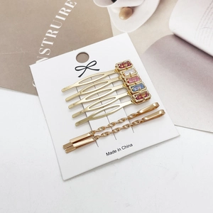 Gouden haaraccessoires set met kleurrijke strass kam en elegante metalen spelden