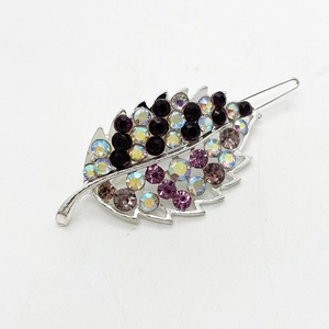 Detailed view of leaf-shaped hair clip with purple and grey rhinestones on silver alloy