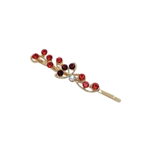 Barrette florale élégante avec strass rouges et blancs sur une base dorée