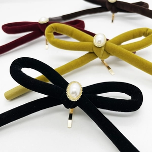 Handmade velvet bow hair clips with large pearl accents in multiple stylish colors