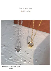 Detail of round pendant necklaces in gold and silver finish on textured surface