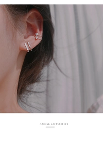 Detailed view of silver layered ear cuff set with rhinestones and minimalist bead texture