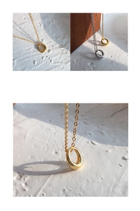 Macro detail of high-polish donut pendant showing thick solid ring craftsmanship