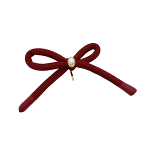 Handmade burgundy velvet bow hair clip with a central pearl in a gold metal base