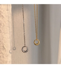 Detailed view of circular gold and silver necklaces with polished finish and cross chains