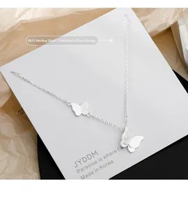 Detail of S925 sterling silver butterfly pendant necklace with elegant double layered design