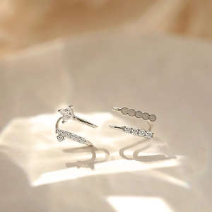 Asymmetric silver double-layer ear cuff with zircon stones on matte ceramic background