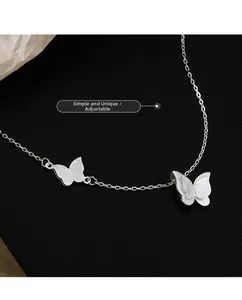 Detail of silver butterfly necklace showing double-layer pendant and adjustable chain